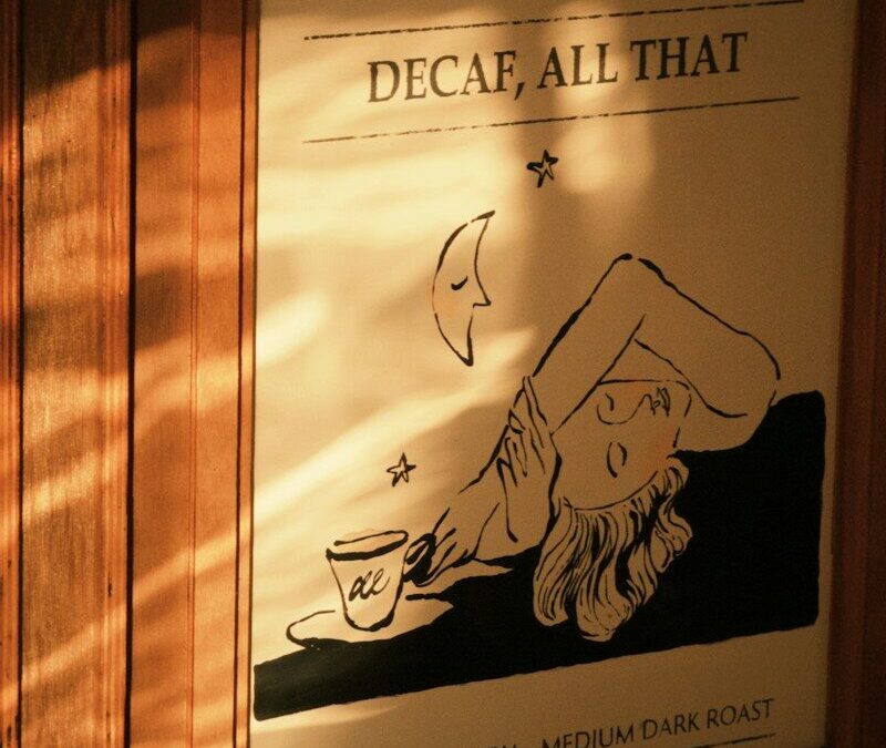 A framed print reading DECAF, ALL THAT with a person and coffee cup
