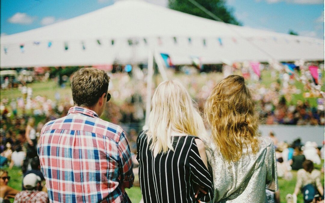 three person's standing front of field